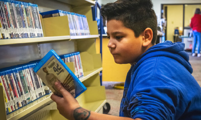 A teenager looking at a BluRay