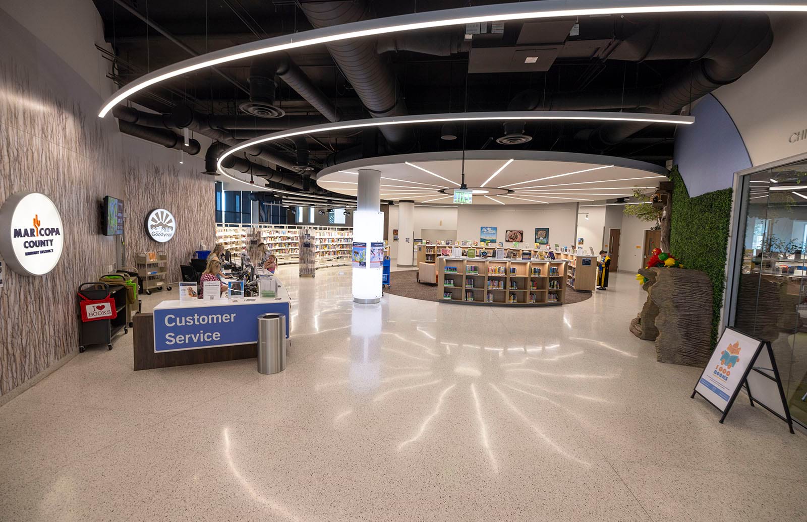 Photo from the north entrance of the library of the Customer Service desk and kids shelves